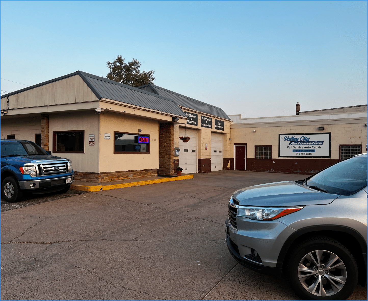 About us at Valley City Automotive in Eau Claire, WI. About us image of the shop's front with two parked car.