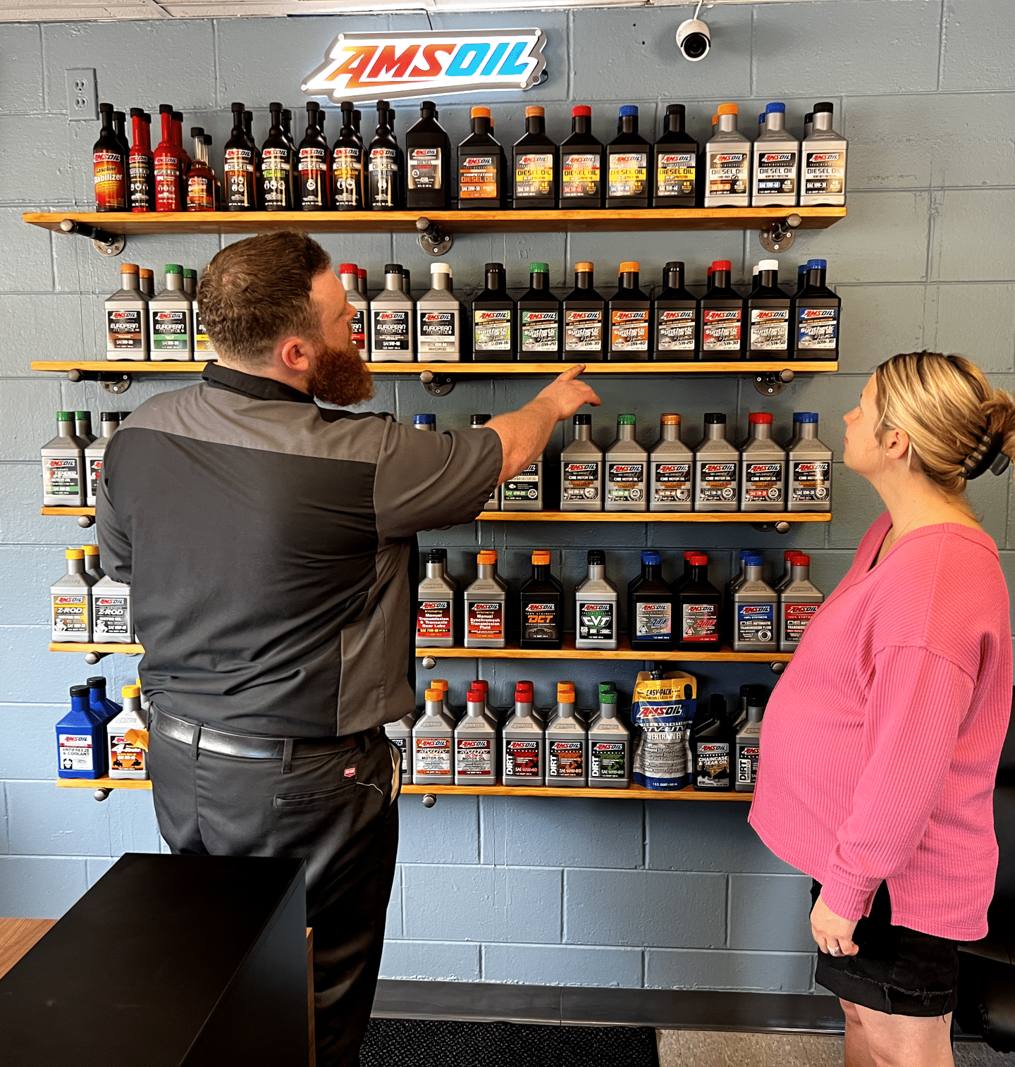 Person discussing products on shelves.